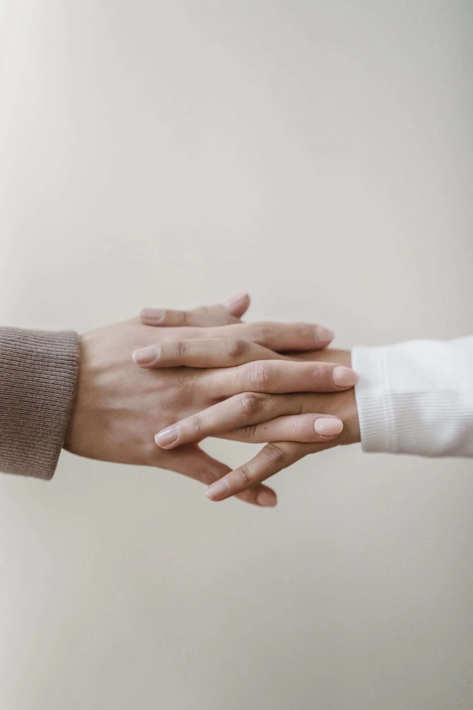 Two hands entwined, symbolising community care and support