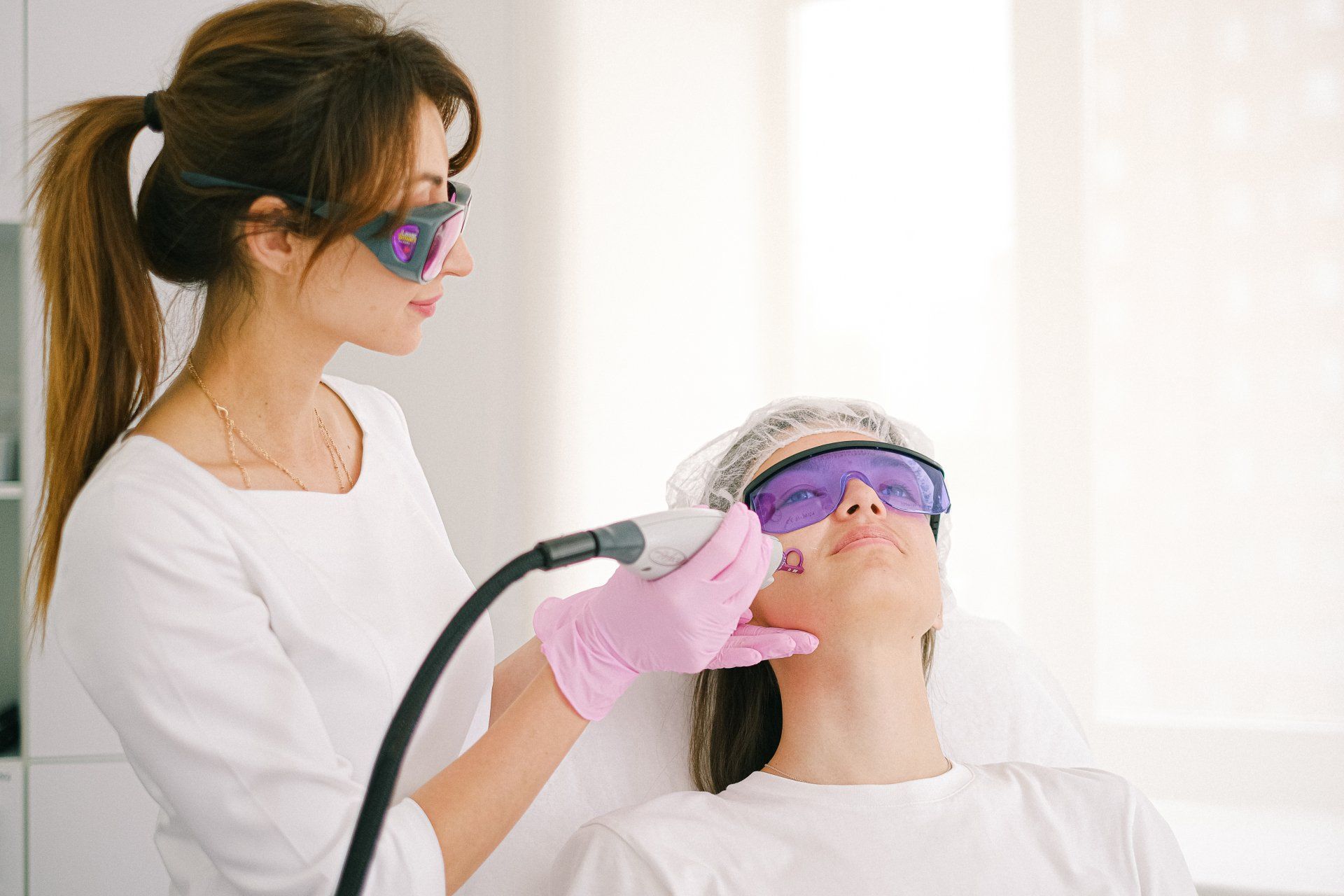 Medical laser treatment being applied to a patient's jaw